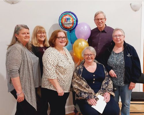 Joyce Bigelow (seated) with Connections Adult Learning staff ater her retirement party.